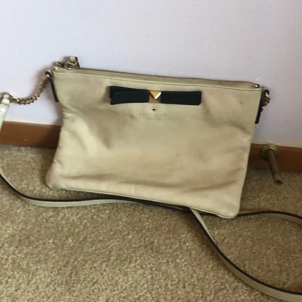 Kate Spade cream purse with a black bow